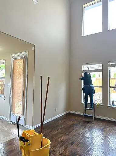 Woman-cleaning-the-corners-of-a-window-during-a-move-out-cleaning-in-Plano