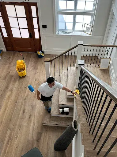 Ali-Maid-professional-cleaner-meticulously-cleaning-the-stairs-during-a-move-in-clean-in-Dallas